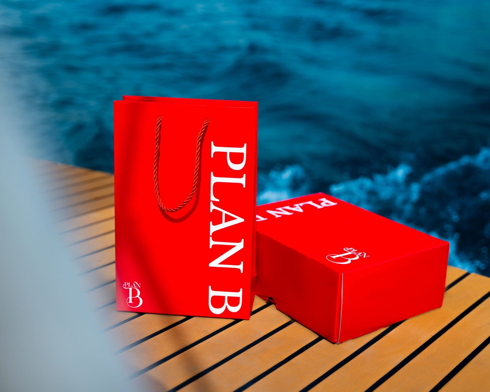 Plan B perfume gift bag and box on a yacht deck in Aqaba